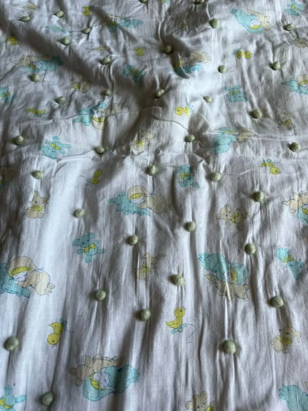 Vintage Style Baby Nursery Crib Quilt with Pom-Pom Accents and Animal Print